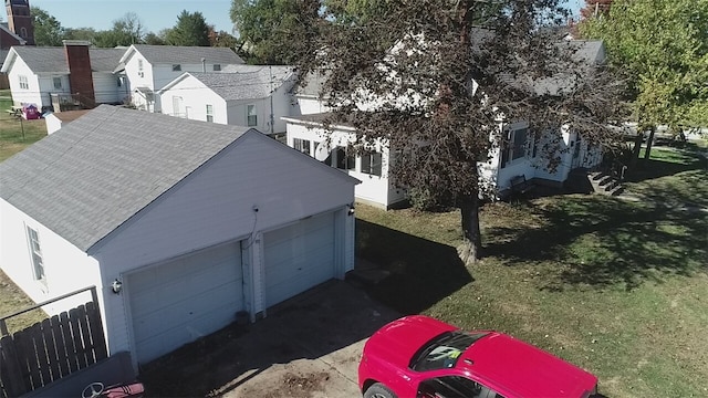 exterior space with a garage, a yard, and an outbuilding