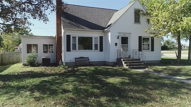 view of front facade with a front yard and cooling unit