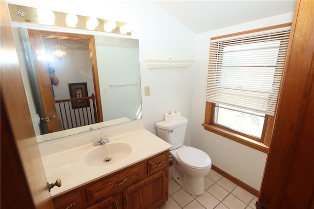 bathroom featuring tile patterned flooring, vanity, vaulted ceiling, and toilet