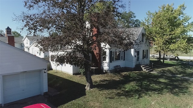 view of property exterior featuring a yard, cooling unit, and a garage