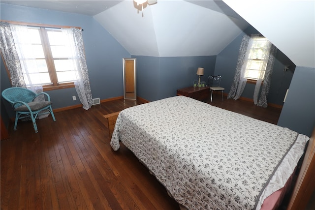 bedroom with dark hardwood / wood-style floors, vaulted ceiling, and ceiling fan