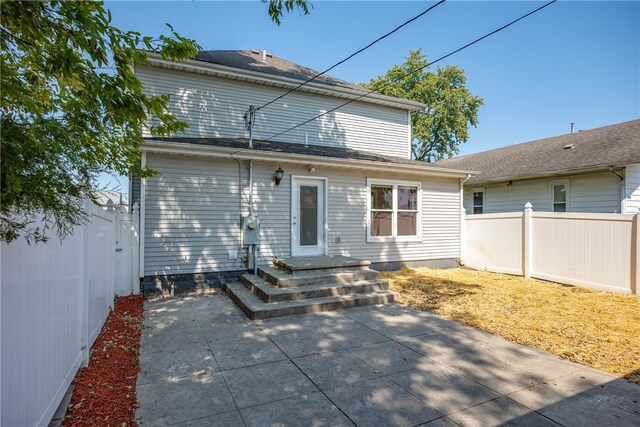 rear view of property featuring a patio area