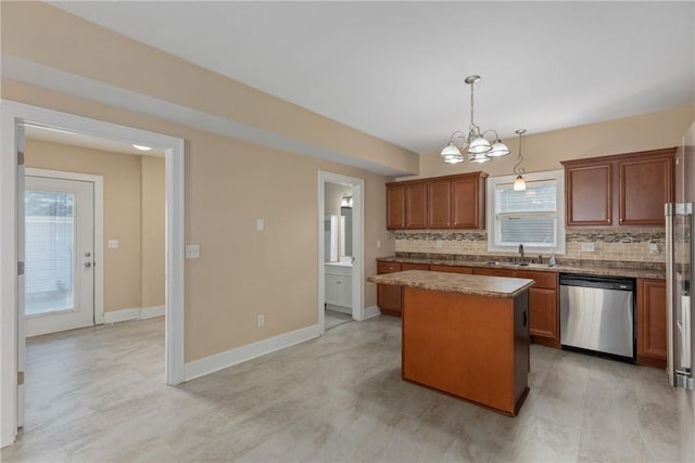 407 Edgar Ave, Effingham, IL 62401 - kitchen featuring stainless steel dishwasher, a center island, decorative backsplash, and hanging light fixtures