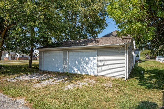 garage featuring a yard