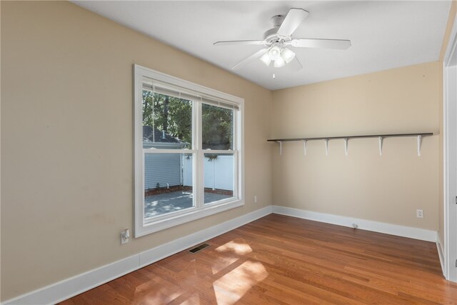 unfurnished room with hardwood / wood-style floors and ceiling fan