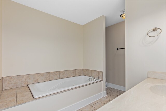 bathroom featuring tile patterned floors, a tub, and sink