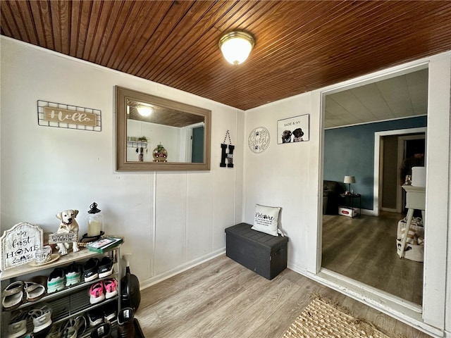 interior space featuring light hardwood / wood-style floors and wood ceiling