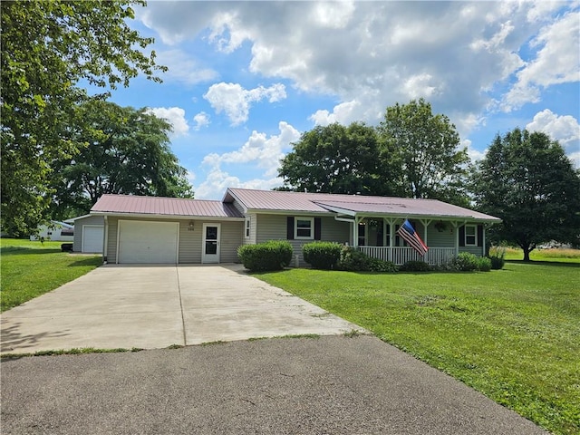 308 S Missouri St, Toledo, IL 62468 - ranch-style home with a garage, concrete driveway, a front lawn, a metal roof, and covered porch