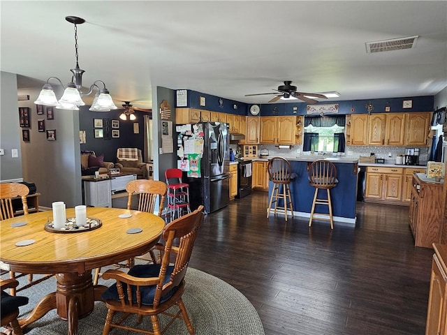 308 S Missouri St, Toledo, IL 62468 - dining space featuring a ceiling fan, dark wood-style flooring, and a chandelier