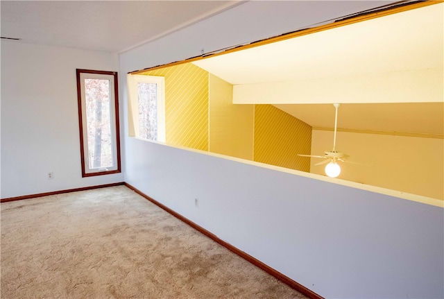 spare room featuring carpet flooring, ceiling fan, and lofted ceiling