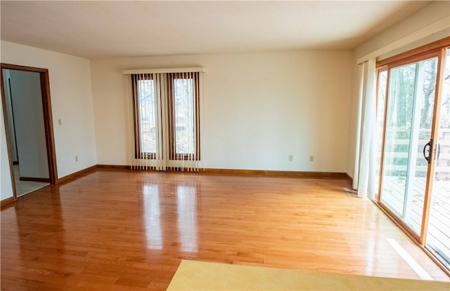 empty room featuring hardwood / wood-style flooring and a healthy amount of sunlight