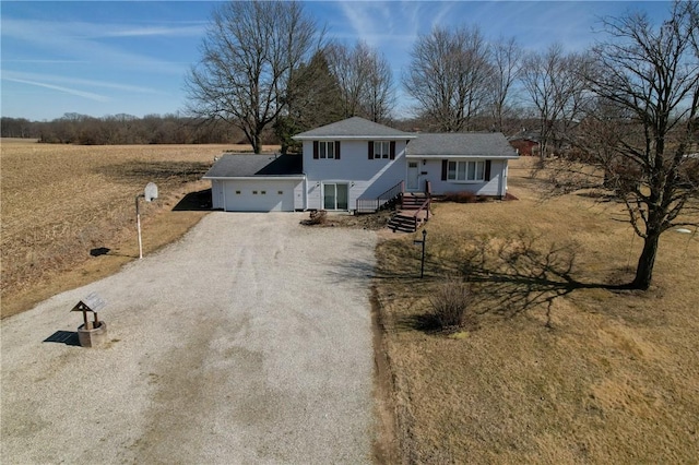 tri-level home featuring a garage and driveway