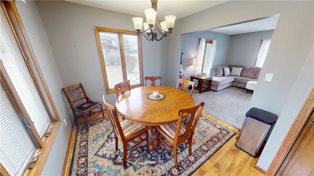 dining space with an inviting chandelier and wood finished floors