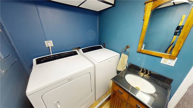 interior space with laundry area, a sink, and washer and dryer