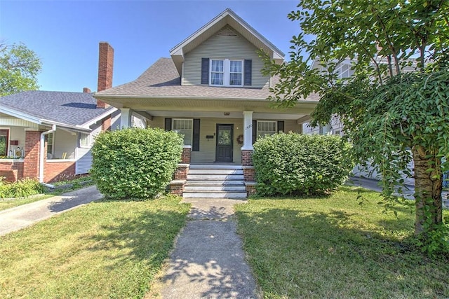 1470 W Decatur St, Decatur, IL 62522 - bungalow-style home with covered porch, a front lawn, roof with shingles, and a chimney
