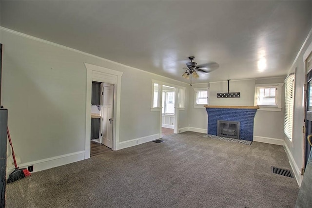 1470 W Decatur St, Decatur, IL 62522 - unfurnished living room featuring a ceiling fan, carpet flooring, a fireplace with flush hearth, and crown molding