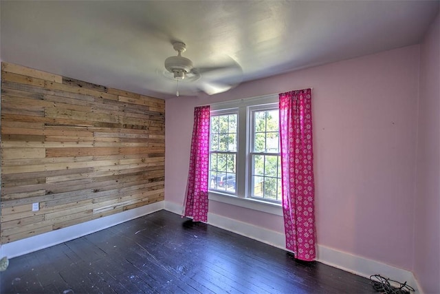 1470 W Decatur St, Decatur, IL 62522 - unfurnished room with ceiling fan, wooden walls, and dark wood-style flooring
