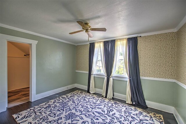 1470 W Decatur St, Decatur, IL 62522 - unfurnished bedroom featuring crown molding, hardwood / wood-style floors, wallpapered walls, and a ceiling fan