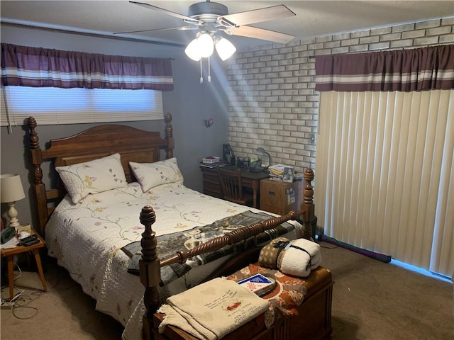 bedroom featuring carpet floors, brick wall, and a ceiling fan