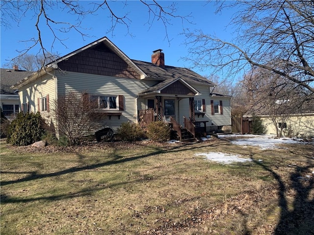 bungalow-style home with a chimney and a front lawn