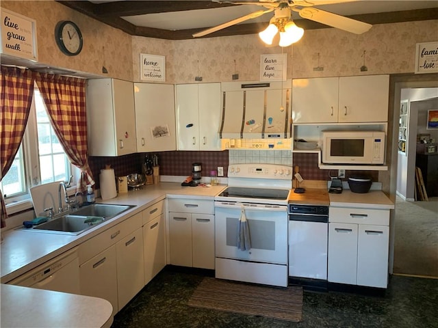 kitchen with white cabinets, white appliances, light countertops, and a sink