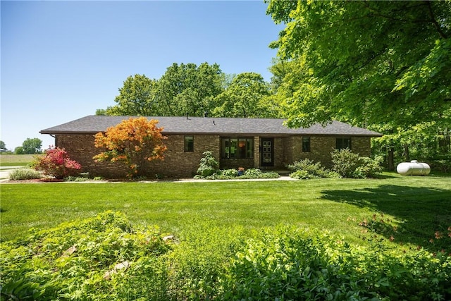 single story home featuring a front lawn and brick siding