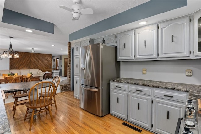kitchen with stainless steel refrigerator with ice dispenser, ceiling fan, light wood-style flooring, a chandelier, and recessed lighting