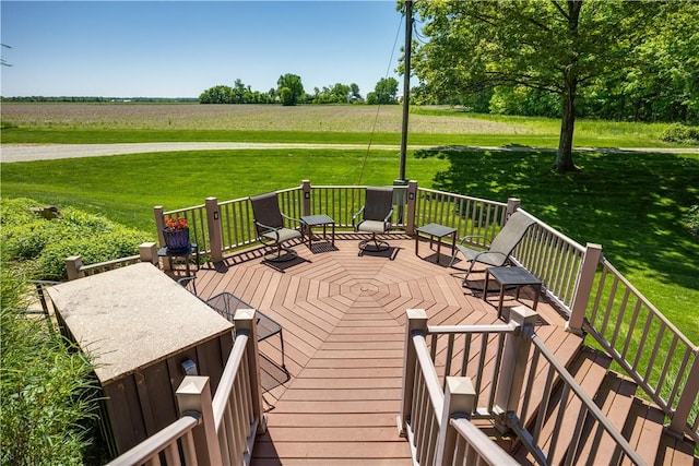 deck featuring a view of rural / pastoral area and a lawn