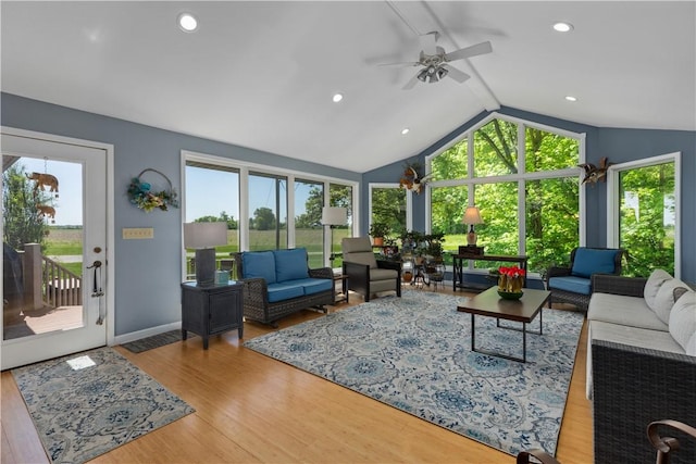 living room featuring a ceiling fan, lofted ceiling, wood finished floors, recessed lighting, and baseboards