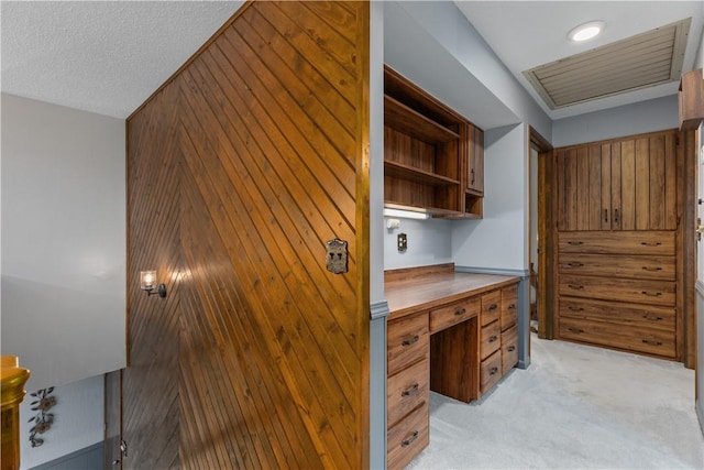 office space featuring wood walls and light carpet