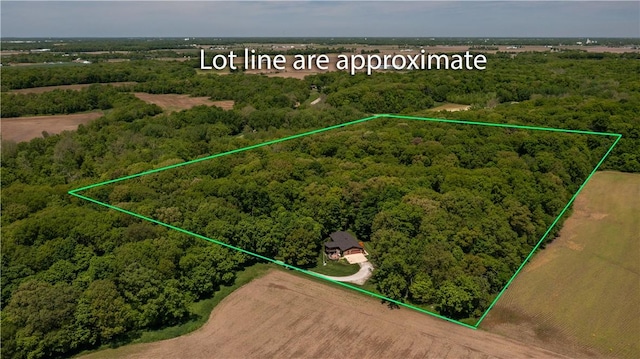 aerial overview of property's location with property parcel outlined and a forest