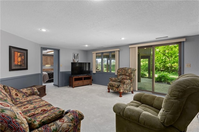 carpeted living room with a textured ceiling and recessed lighting