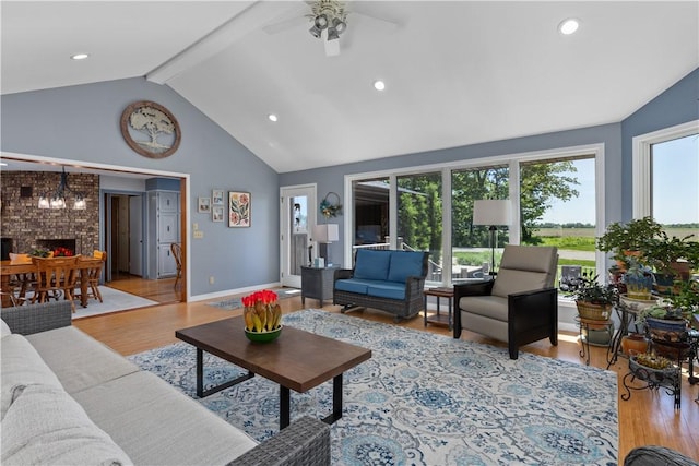 living room featuring healthy amount of natural light, wood finished floors, ceiling fan, beamed ceiling, and recessed lighting