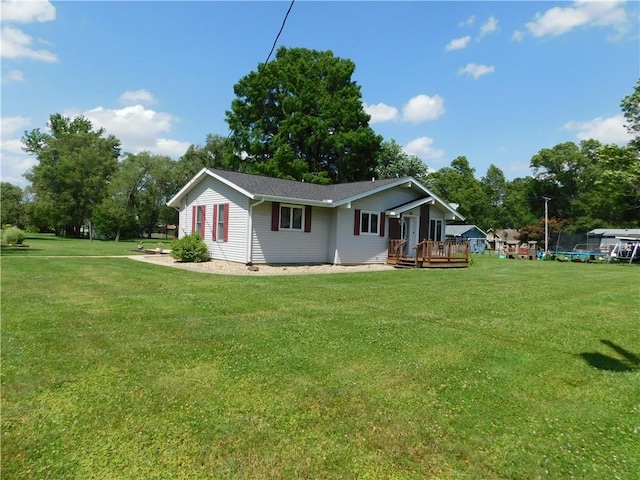 205 Monroe St, Toledo, IL 62468 - back of property featuring a yard, a deck, a trampoline, and view of wooded area