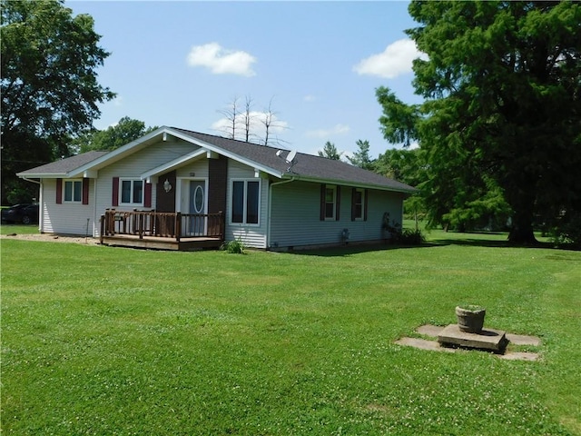 205 Monroe St, Toledo, IL 62468 - rear view of property featuring a lawn and a wooden deck