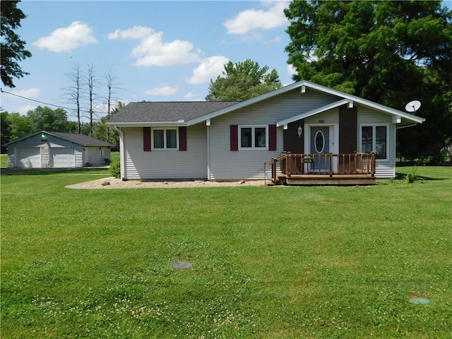 205 Monroe St, Toledo, IL 62468 - view of front of property featuring a wooden deck, a front lawn, and a detached garage