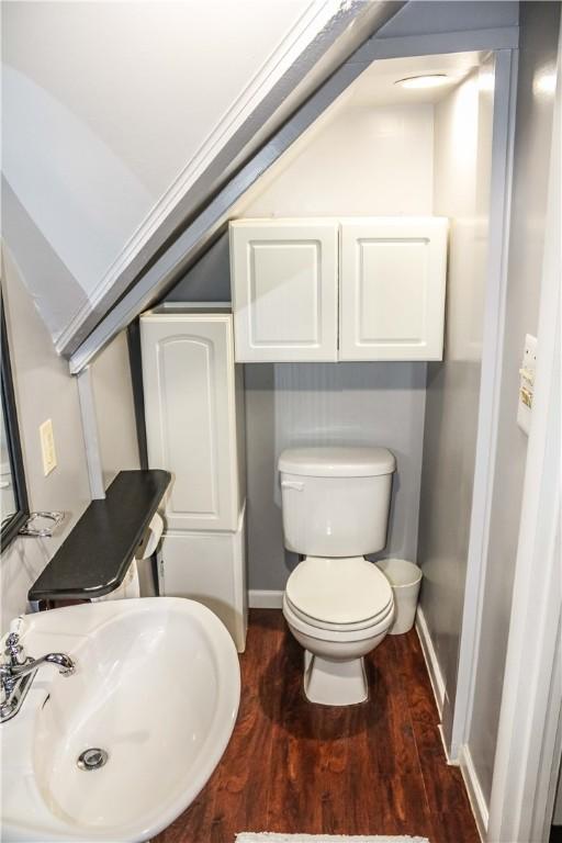 3416 Western Ave, Mattoon, IL 61938 - half bathroom featuring a sink, toilet, wood finished floors, and baseboards