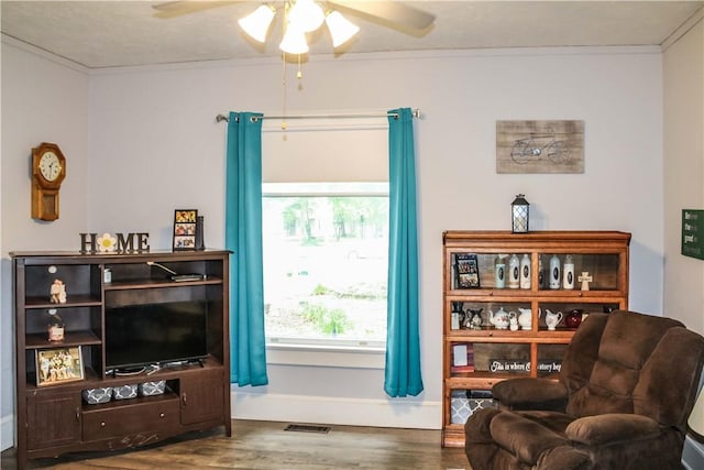 3416 Western Ave, Mattoon, IL 61938 - living area featuring ceiling fan, wood finished floors, ornamental molding, and baseboards