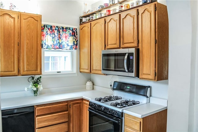 3416 Western Ave, Mattoon, IL 61938 - kitchen featuring range with gas stovetop, stainless steel microwave, dishwasher, and light countertops