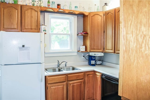 3416 Western Ave, Mattoon, IL 61938 - kitchen featuring freestanding refrigerator, black dishwasher, a sink, light countertops, and brown cabinetry