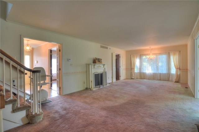 1225 W Pineview Ct, Decatur, IL 62526 - unfurnished living room with a chandelier, plenty of natural light, stairs, carpet flooring, and ornamental molding