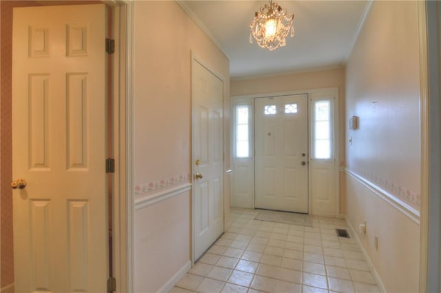 1225 W Pineview Ct, Decatur, IL 62526 - foyer entrance featuring light tile patterned floors, a chandelier, and ornamental molding