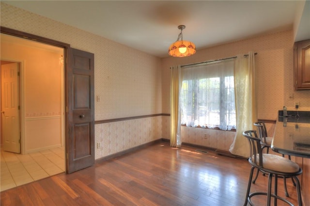 1225 W Pineview Ct, Decatur, IL 62526 - dining space featuring wallpapered walls and wood finished floors