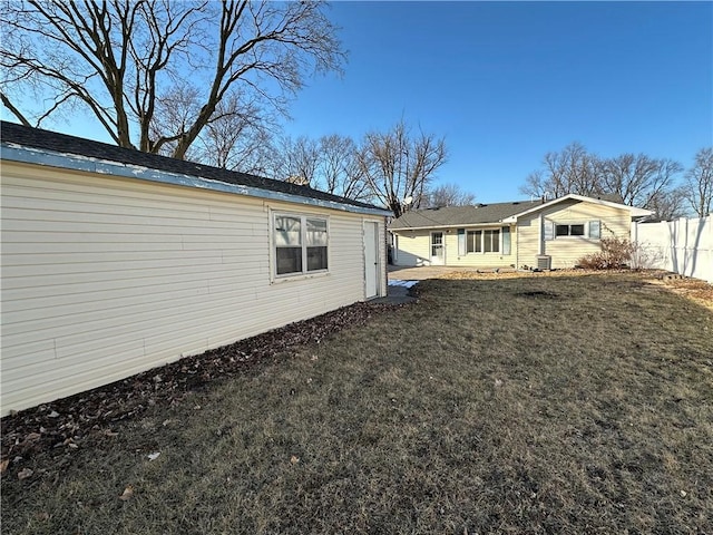 exterior space featuring fence and a lawn