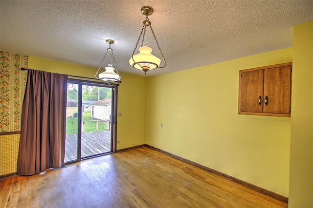 3103 N Oakland Ave, Decatur, IL 62526 - spare room featuring light wood finished floors, a textured ceiling, and baseboards
