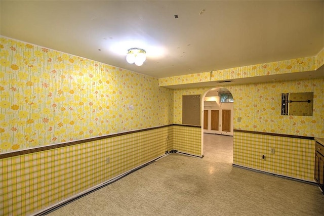 3103 N Oakland Ave, Decatur, IL 62526 - unfurnished room with wallpapered walls, arched walkways, and a wainscoted wall