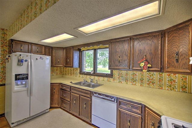 3103 N Oakland Ave, Decatur, IL 62526 - kitchen with white appliances, a sink, light countertops, wallpapered walls, and a textured ceiling