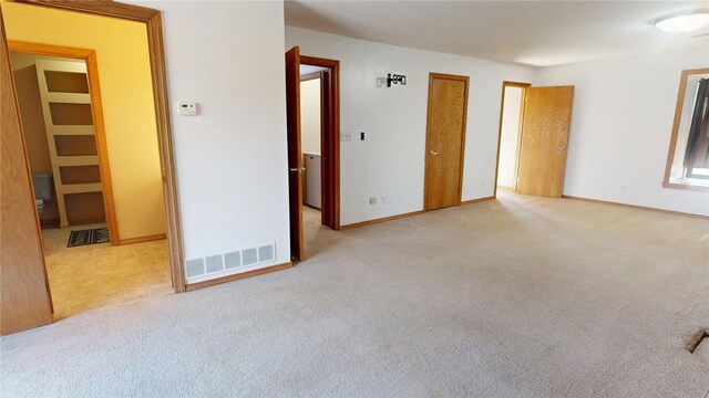29 Peckerwood Ct, Bethany, IL 61914 - unfurnished bedroom featuring ensuite bath, baseboards, visible vents, and light colored carpet