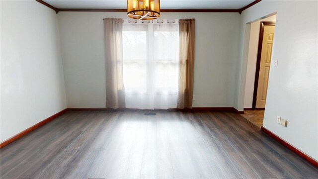 29 Peckerwood Ct, Bethany, IL 61914 - spare room featuring a notable chandelier, crown molding, baseboards, and wood finished floors