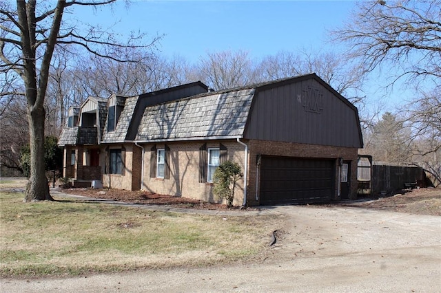 29 Peckerwood Ct, Bethany, IL 61914 - exterior space with mansard roof, a balcony, a garage, brick siding, and driveway